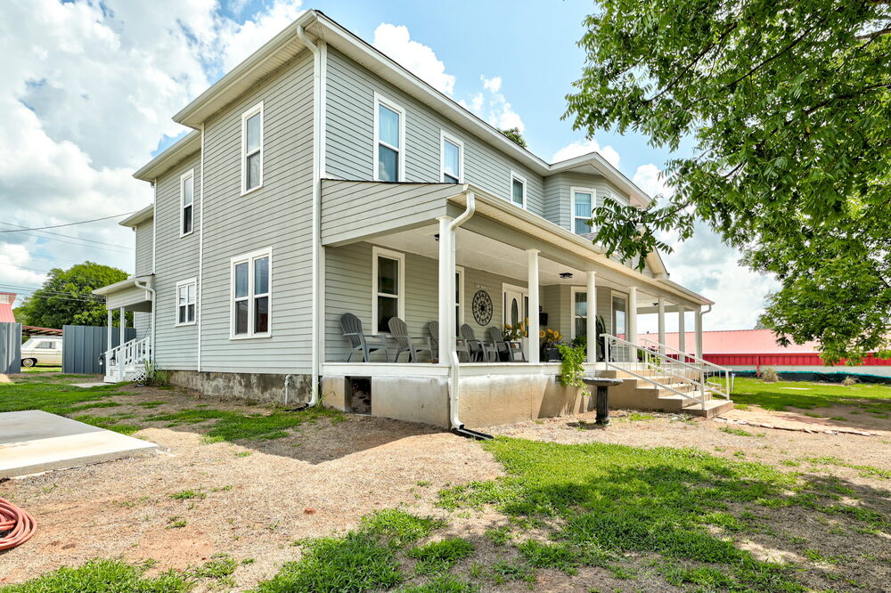 The house from the side — two proud stories and the wrap-around porch
